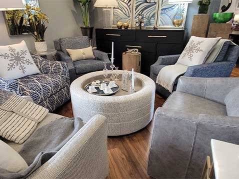 A group of comfortable chairs set around a round coffee table